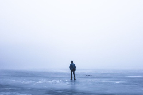 Man standing alone in the middle of nowhere.